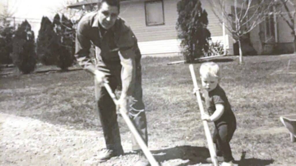 Alan as a child working in the yard with his dad