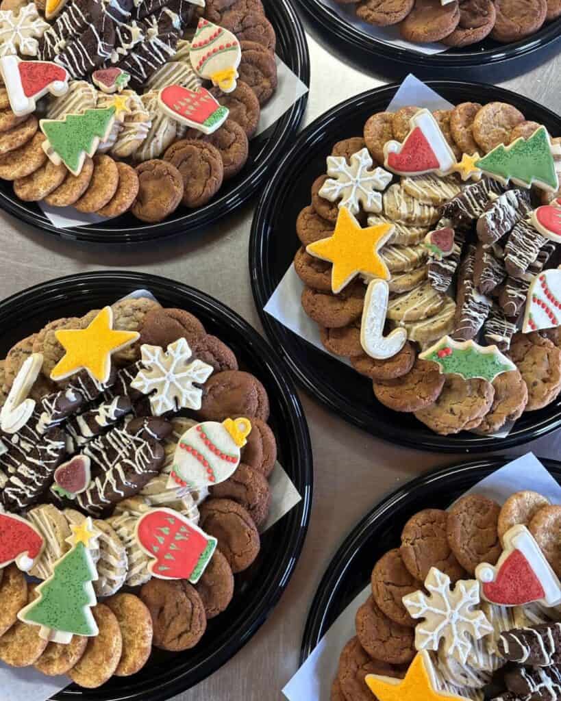 Multiple trays of Christmas cookies