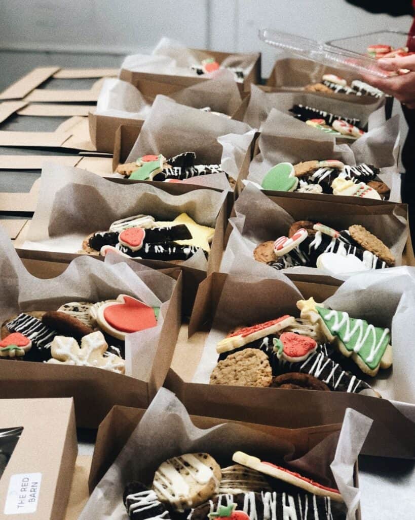 A set of boxes being packed with Christmas cookies