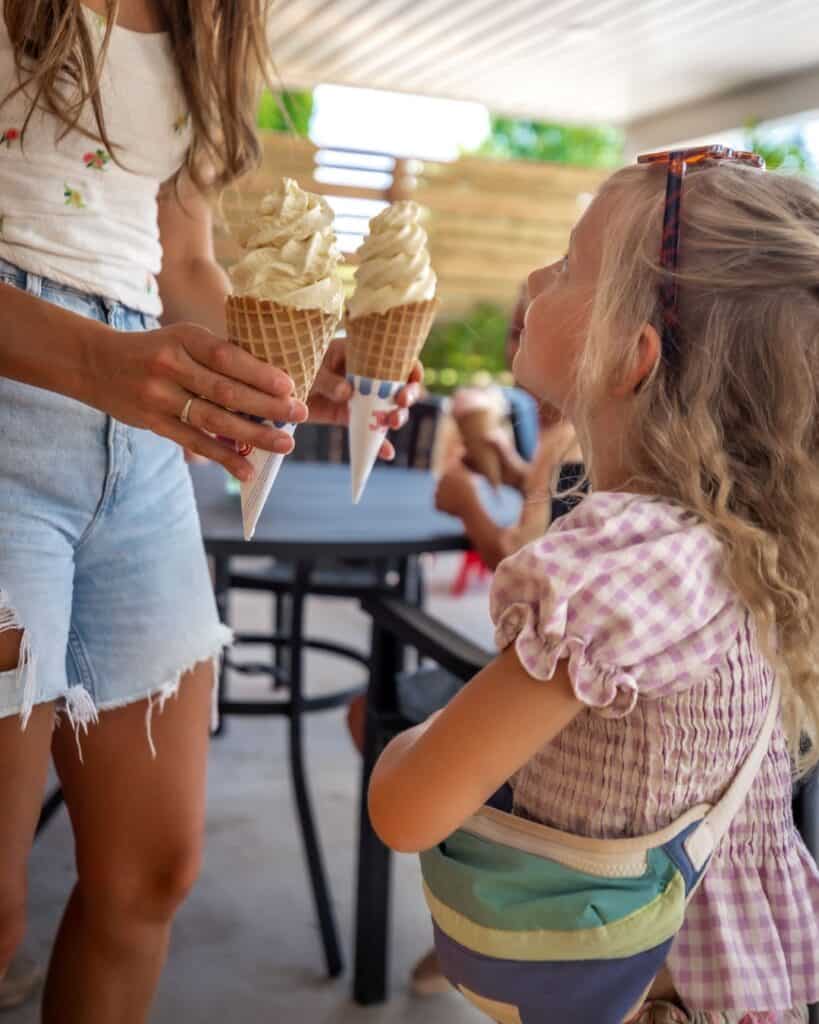 Little girl being handed frozen yogurt