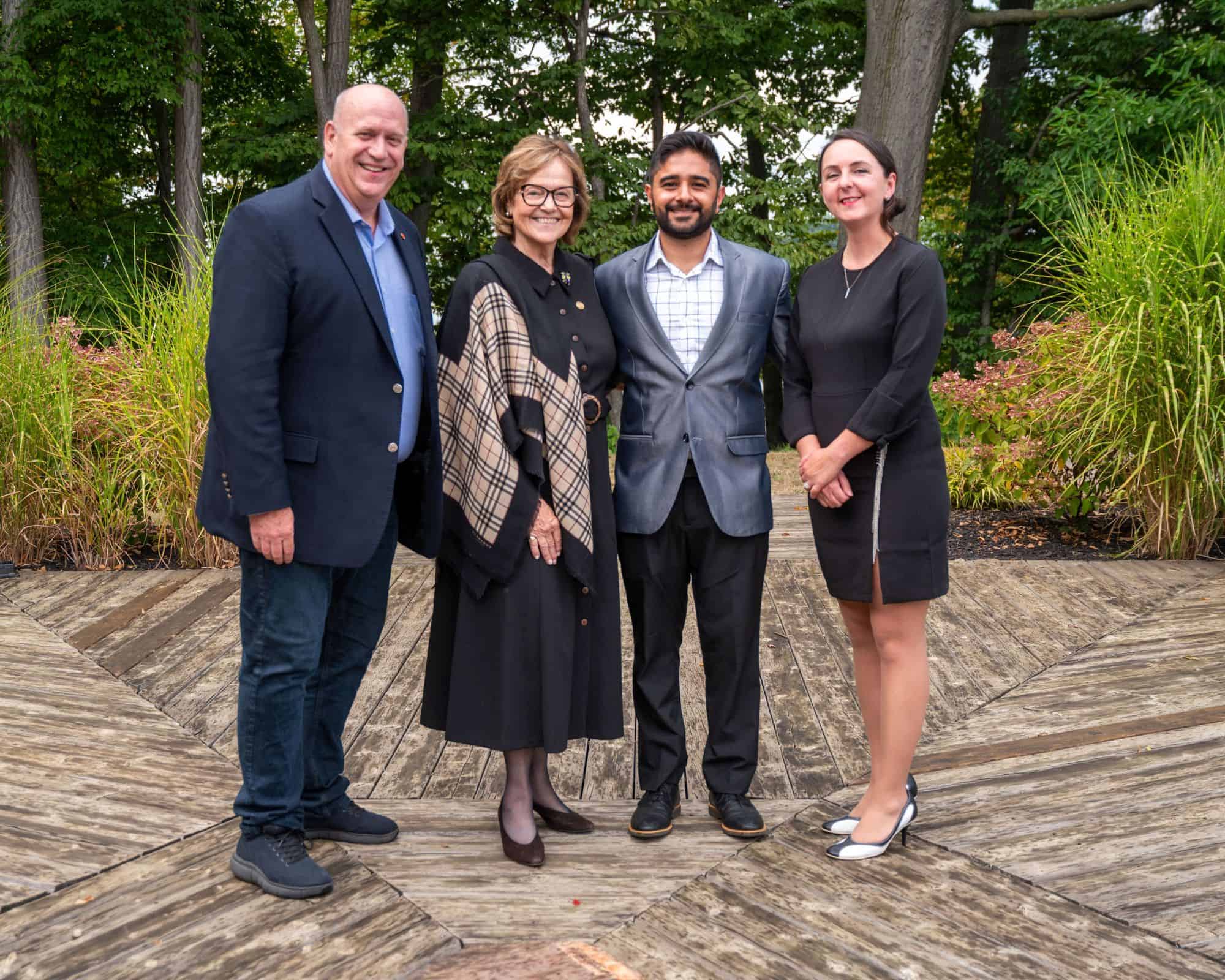 Geet from Geet Collective posing with elected officials and the President of the Lincoln Chamber